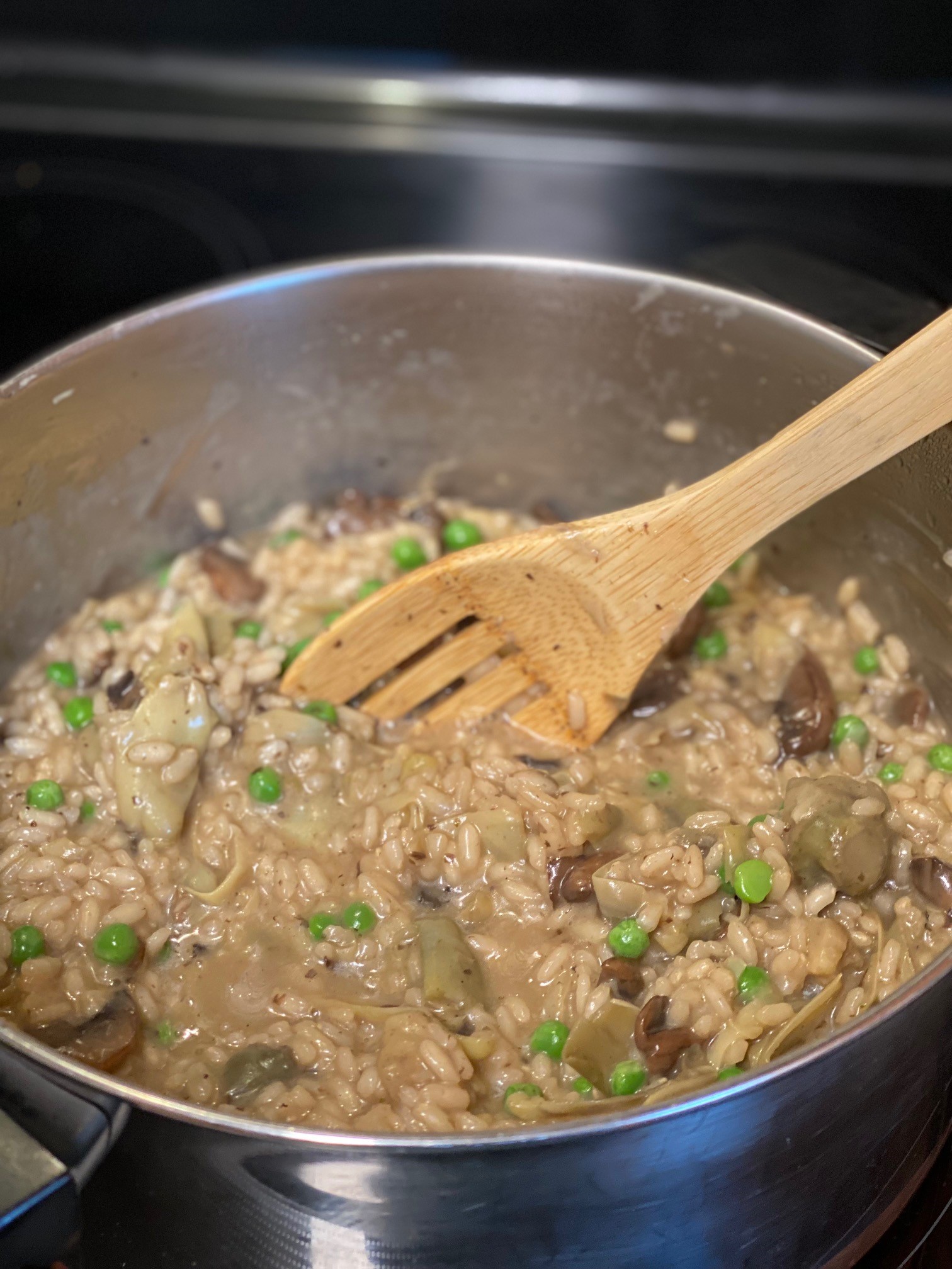 Risotto with mushrooms cooking on stove