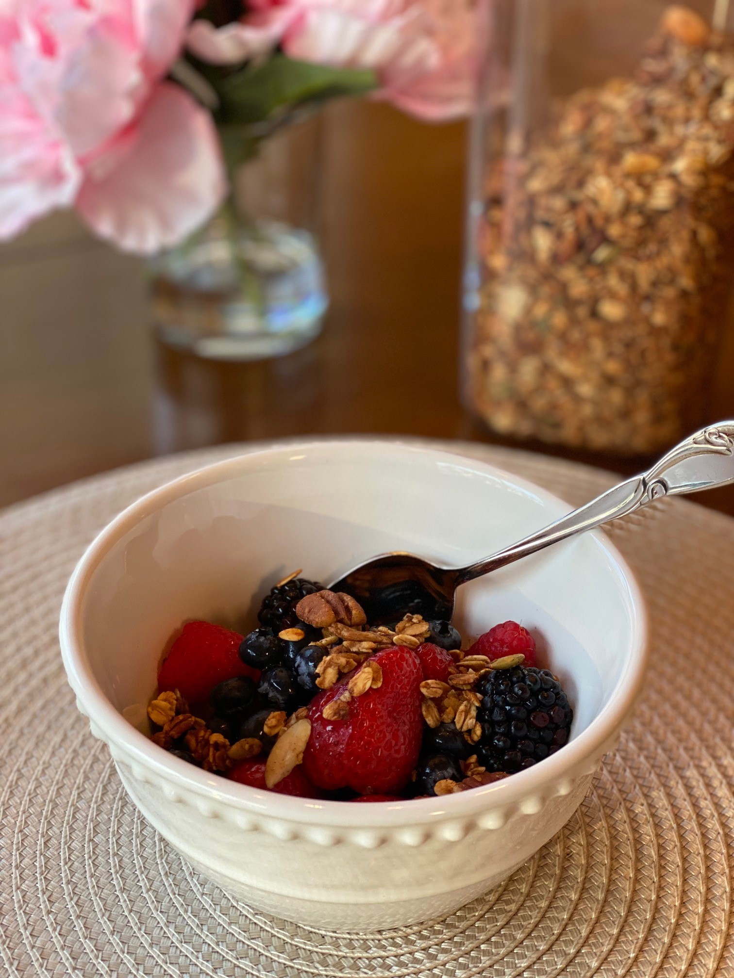 a bowl of berries topped with homemade granola