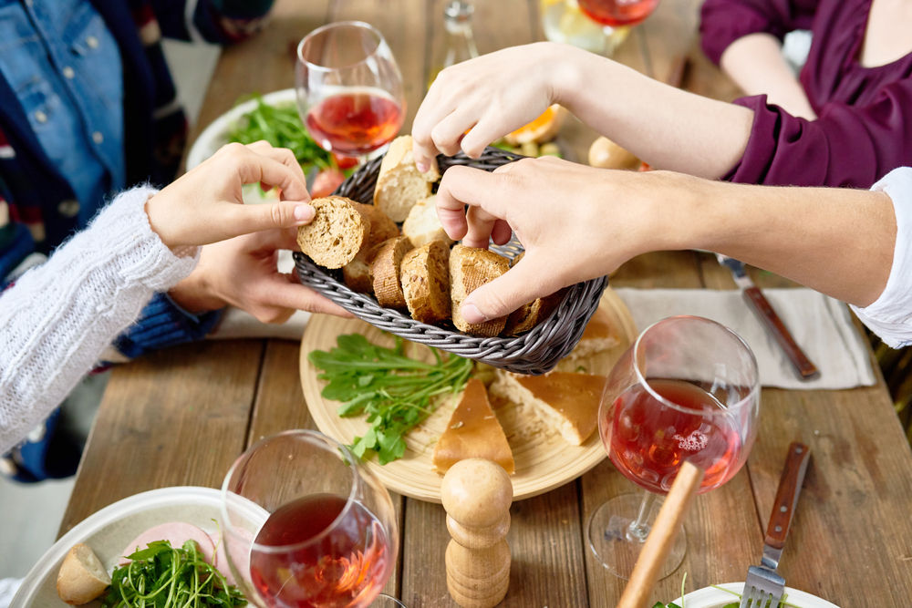 Hands passing food at a table