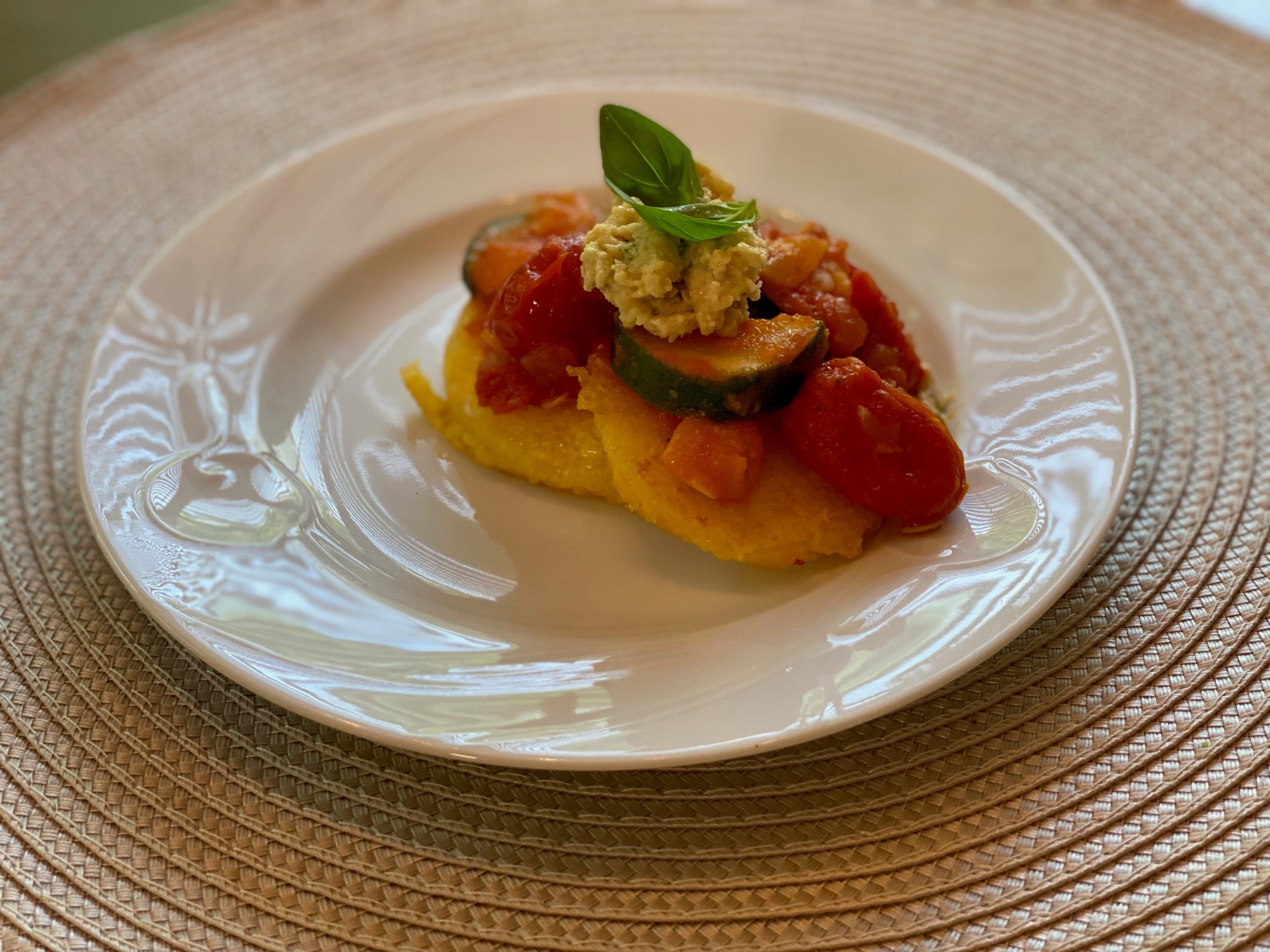 Polenta cakes on a plate with tomato sauce