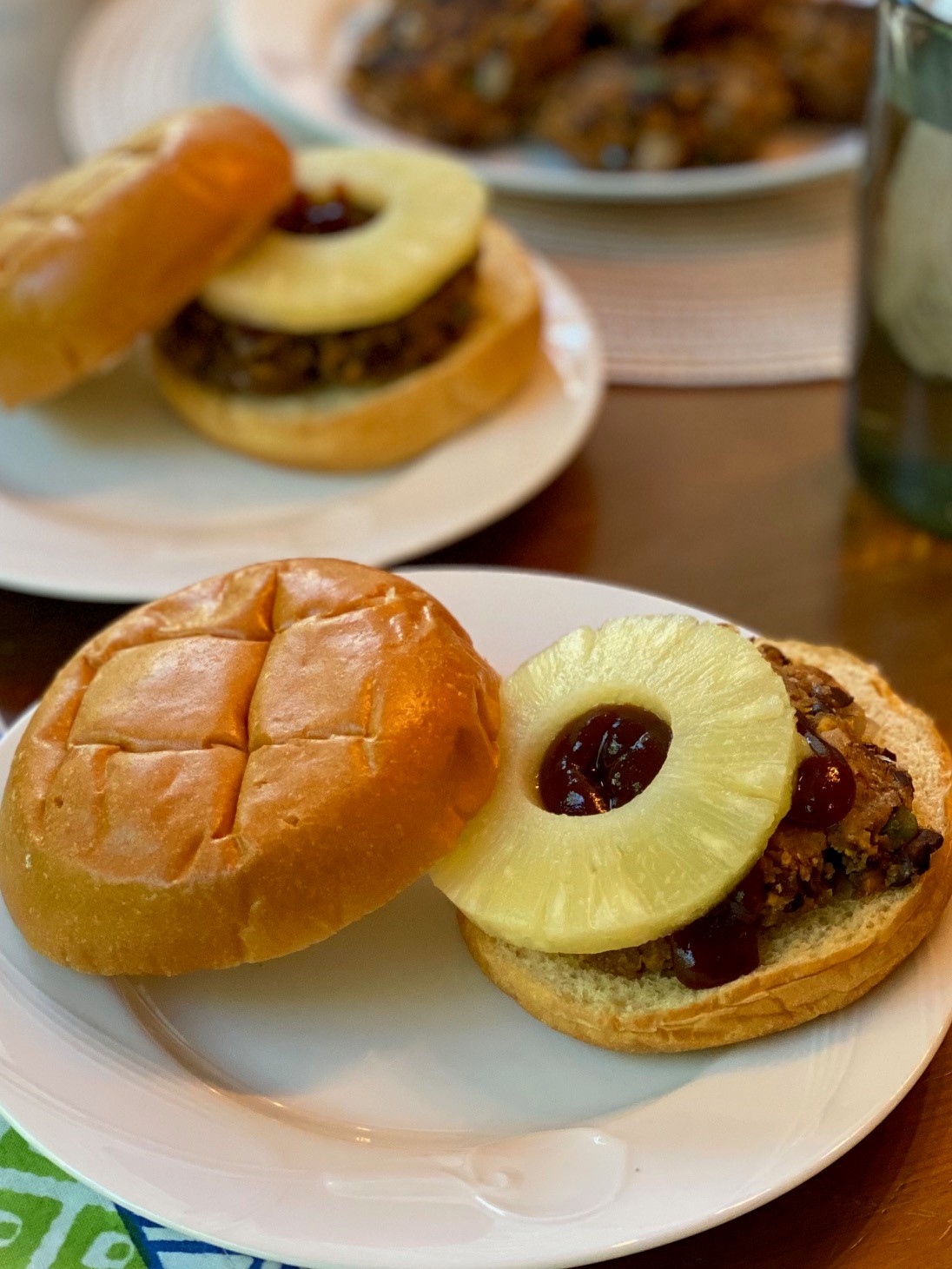 Sweet potato and black bean burger on a hamburger bun with pineapple ring