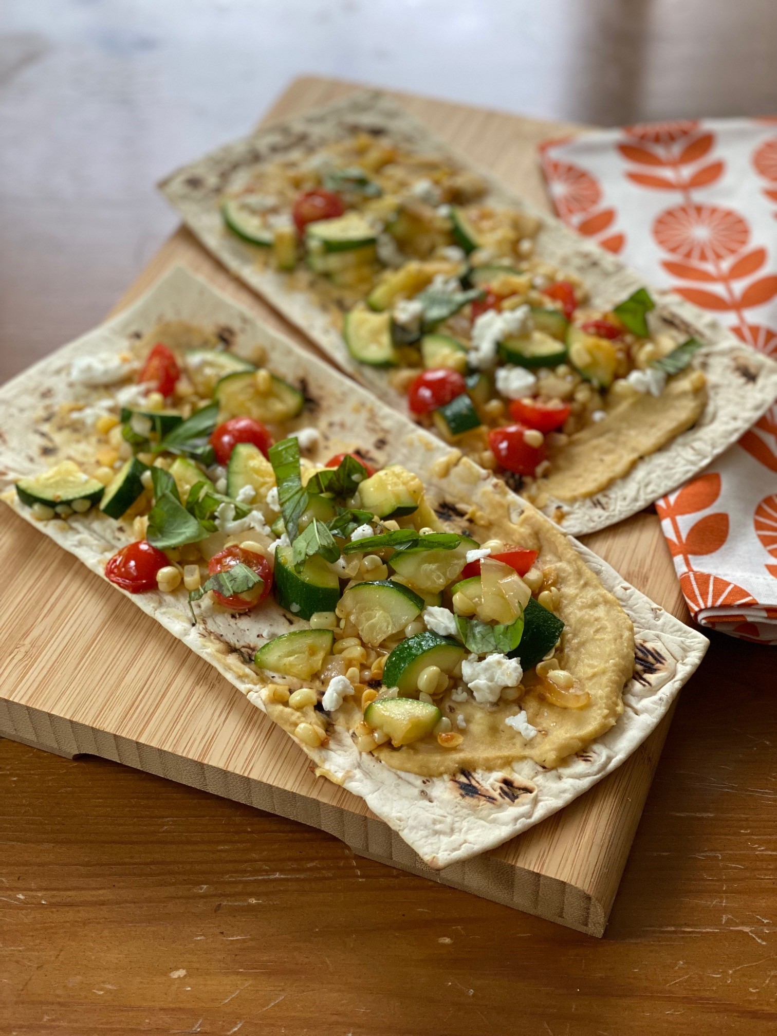 Flatbreads topped with veggies and herbs