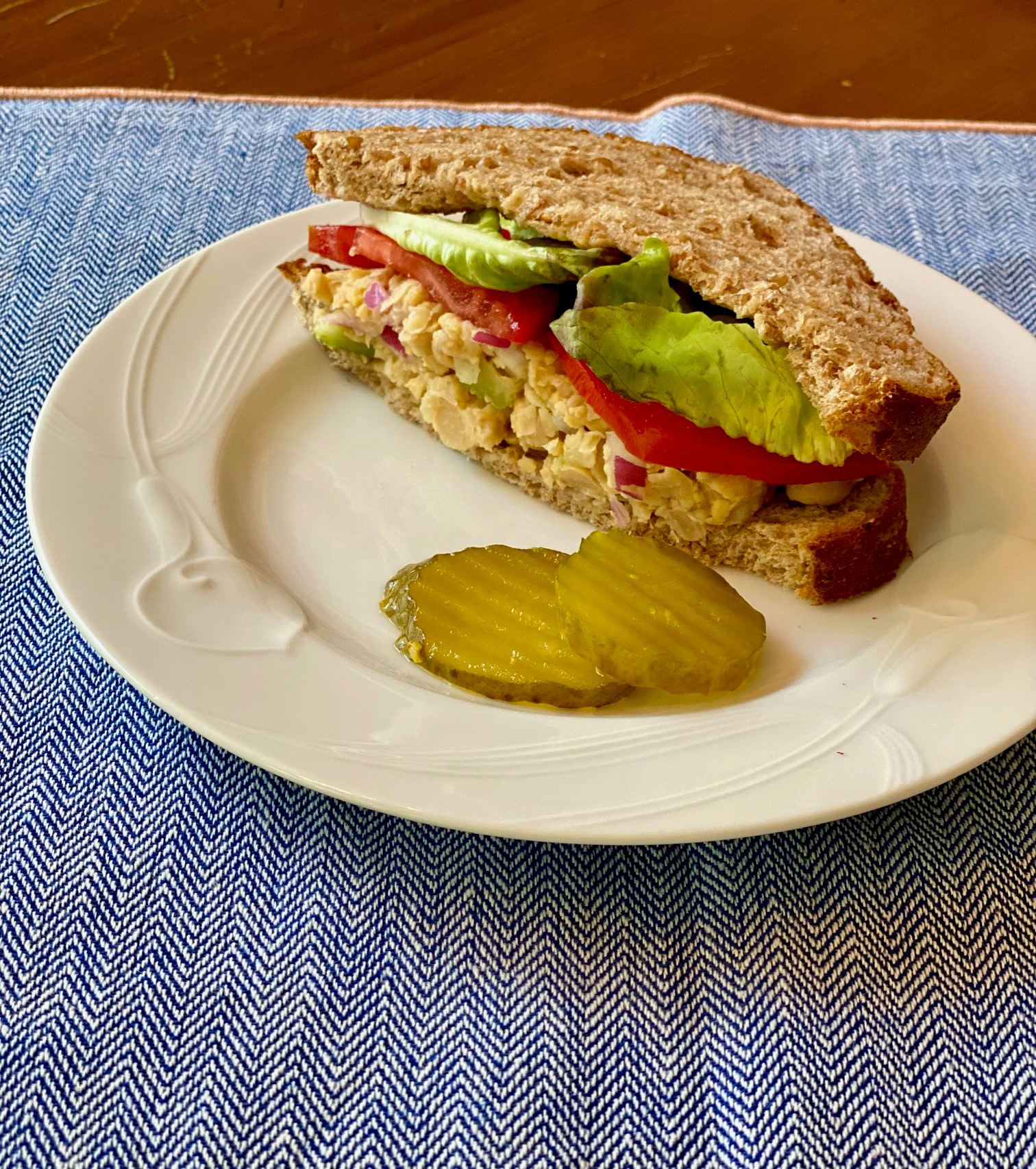 Half of a chickpea salad sandwich on a plate