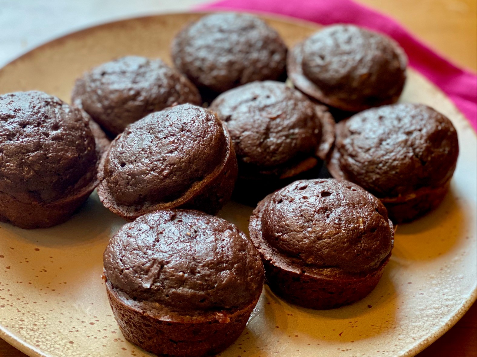 A plate of chocolate zucchini muffins.