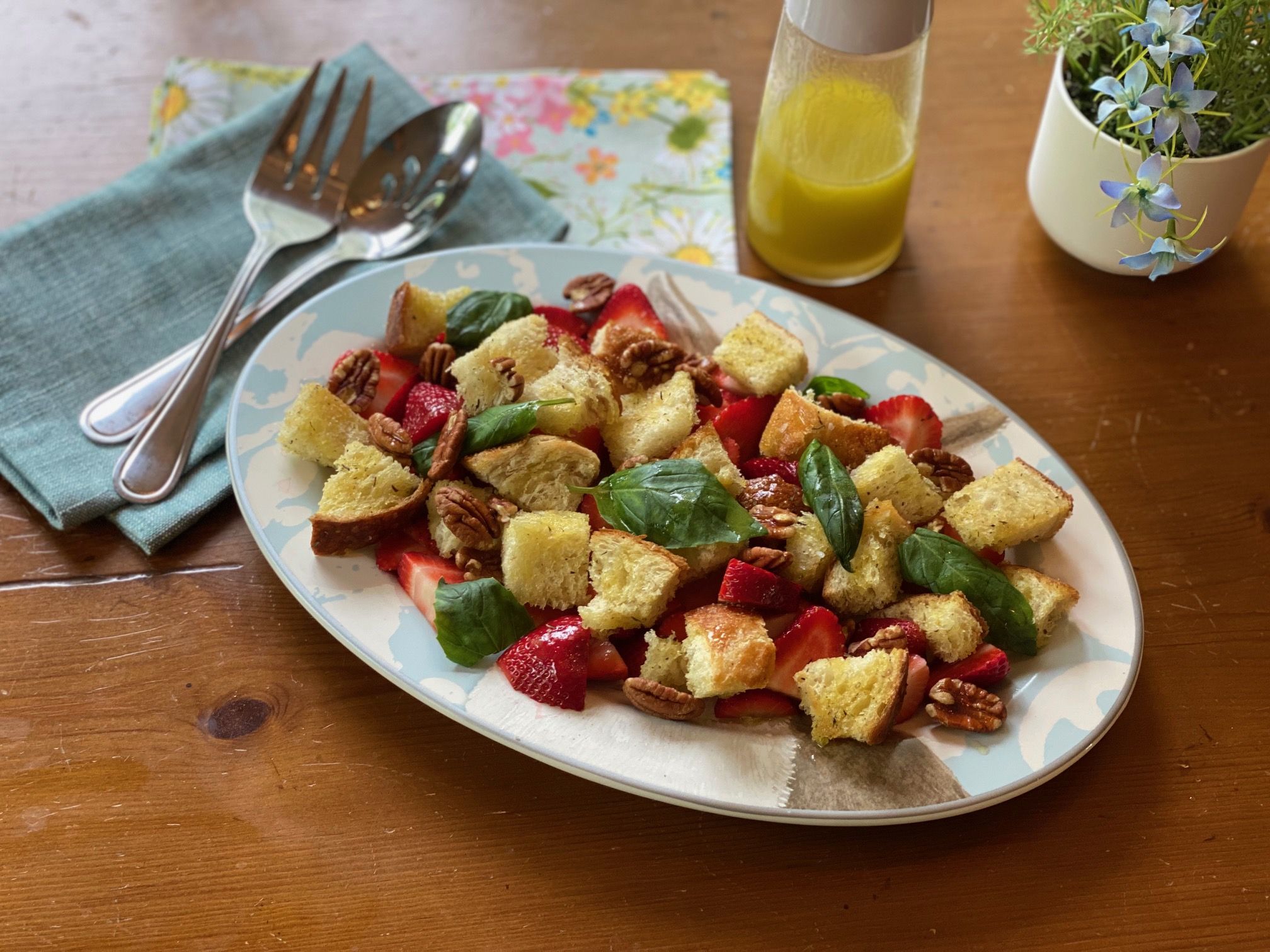 A platter of strawberry panzanella salad.